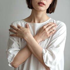 Woman in white top, arms crossed