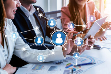A diverse business team engages in collaboration using technology in a modern office. Digital network connections symbolize teamwork and communication for success. Tessel