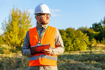 Male engineer inspects the condition of a new construction site. Forestry inspector - environmental control. Conducts environmental monitoring soil analysis. Works as an ecologist. 