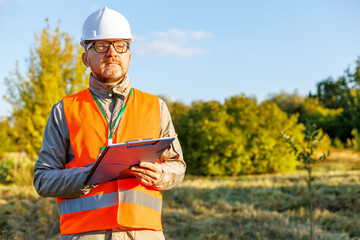 Male engineer inspects the condition of a new construction site. Forestry inspector - environmental control. Conducts environmental monitoring soil analysis. Works as an ecologist. 