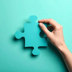 Hand placing teal puzzle piece