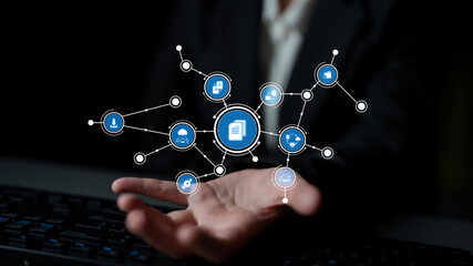 A businessman showcases digital connectivity with abstract technology icons floating above his open hand, symbolizing innovation and communication in a modern world. Tessel
