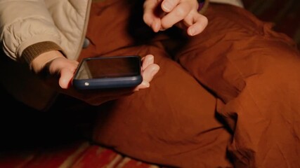 Closeup woman hands holding mobile phone outdoors street autumn colors background relaxing sitting on the bench. Unrecognizable young caucasian woman - Powered by Adobe