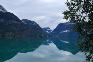 reflection of the sky and mountains in the water - Stryn, Norway