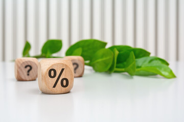 Wooden cube with percent symbol in focus