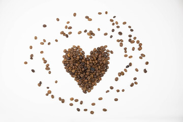 Scattered coffee beans and a cute heart made of coffee beans on a white background