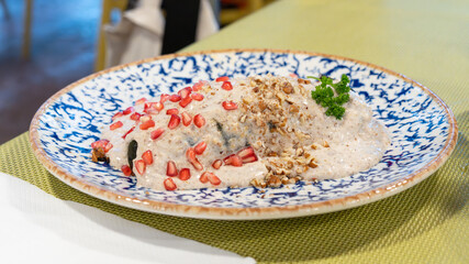 A plate of food with a green tablecloth in the background. The food is a mix of rice and nuts. Historic center of Queretaro, colonial architecture, decorations for the celebration of Mexico's Independ