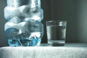 Post an empty plastic bottle and a glass filled with water