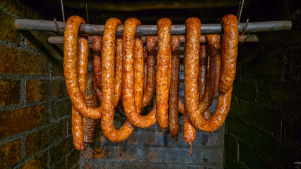Smoking sausages in a traditional smokehouse