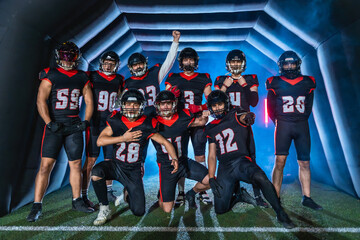 American football players emerging from tunnel for game