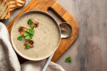 Mushroom soup puree on white kitchen table.