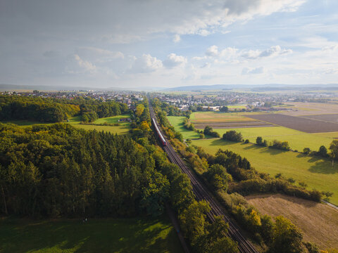 View of the train traveling through the fall landscape in changing weather conditions 