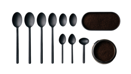 Black spoons and coffee grounds in oval trays
