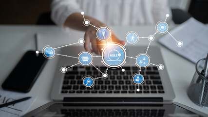 A modern office setting featuring a laptop with digital icons representing agile methodology, showcasing innovation and collaboration in project management strategies. Tessel