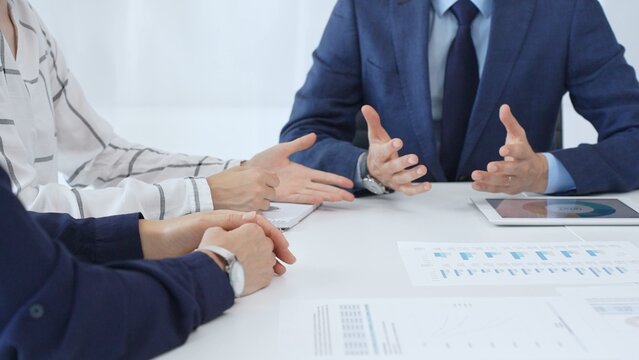 Professional team reviewing financial reports, collaborating on data analysis and strategic insights in modern corporate workspace