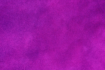 Suede background of purple color. Macro photo of suede genuine leather of purple color.
