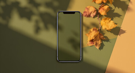 Smartphone with blank screen on autumn-themed background with yellow leaves and shadows