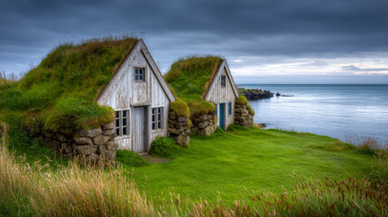 Obraz premium Rustic coastal cottages with grassy roofs overlooking a serene ocean landscape