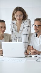 Obraz premium Business people team collaborating on a project, analyzing data on a laptop during a productive office meeting, fostering teamwork and strategic planning