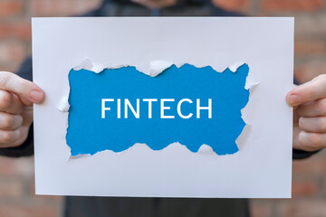 FinTech Financial Technology Cryptocurrency Investment Digital Money Banking Business concept. Person holding white and blue sheets of paper with the inscription FINTECH.