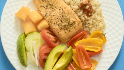 Top view of a meal with grilled salmon, salad and rice.