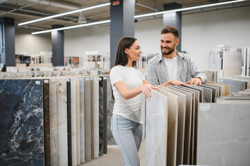 Couple choosing floor tiles for home renovation project