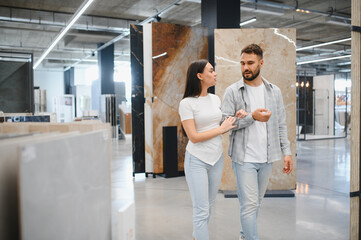 Couple shopping for tiles in home improvement store