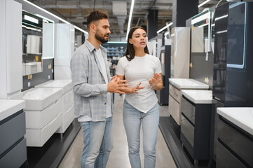 Fototapeta premium Couple discussing bathroom vanity choices in a showroom