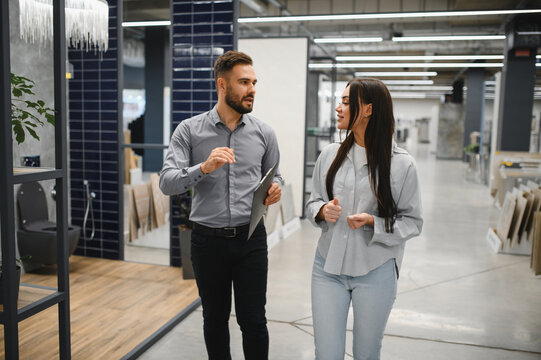 Salesman assisting female customer with home improvement choices