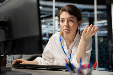Worried server room employee sees error popup on screen while using software to perform computing...