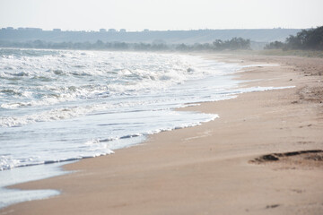 Sandy beach and rolling sea