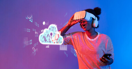 A young woman excitedly interacts with a virtual reality headset while engaging with cloud computing visuals, symbolizing modern technology and digital innovation. XDMCP