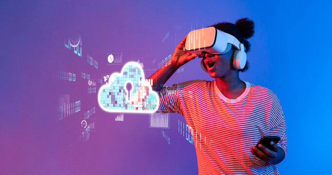 A young woman excitedly interacts with a virtual reality headset while engaging with cloud computing visuals, symbolizing modern technology and digital innovation. XDMCP