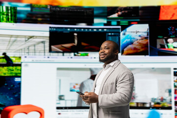 Man looks at videowall showcasing endless streaming channels and social media clips. User watching gaming clips, cooking tutorials and live broadcasts illustrating boundless content choice