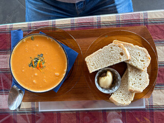 A bowl of potato soup with bread.