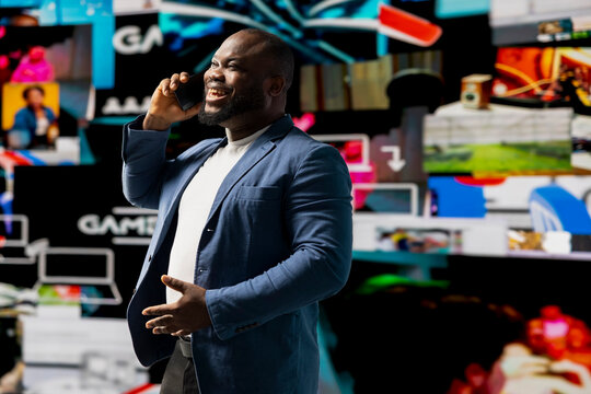 Tech savvy individual discuss about digital content on phone call, using cloud based applications and social media icons to reflect global connection, trends and AI driven influence.