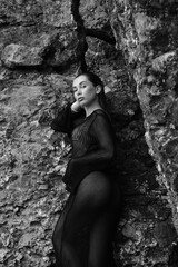 Portrait of woman in bikini on tropical beach near the mountain. Back view