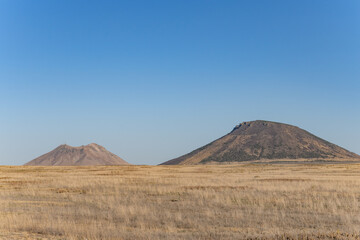 Three Buttes Historical Marker. Volcanic Field. Idaho's eastern Snake River Plain.  East Butte with Middle Butte. lava dome 

