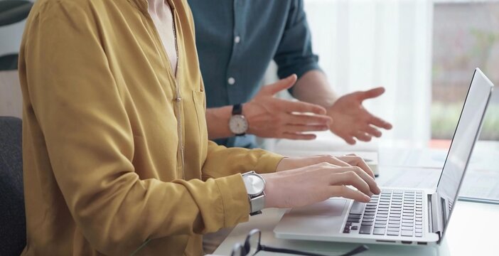 Team collaboration over financial reports. Business people, professionals analyzing financial charts and data on a desk while sitting near a laptop computer