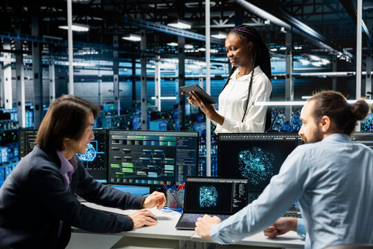 Teamworking data center admins adjusting neural networks model parameters to upgrade systems. Server room IT colleagues scheduling machine learning ran maintenance for infrastructure components