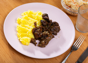 Homemade delicious fried chicken liver served on plate with mashed potatoes