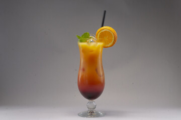 Alcoholic or non alcoholic cocktail in a stylish glass on a gray background, photographed in studio conditions as part of food and beverage product shooting.