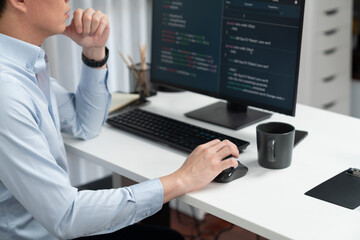 Smart IT developer looking at coding program application on computer screen of online website, analyzing intelligent database system development on business world market at modern office. Infobahn.