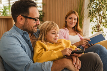 Happy family relaxing together on sofa at home