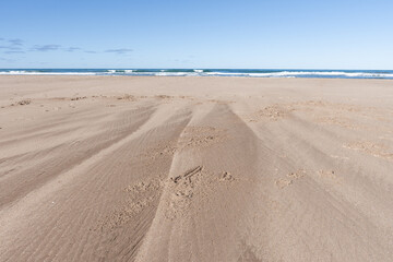 Horizon of sand, sea, and sky.