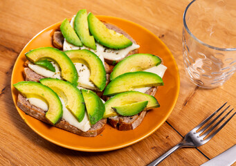 Sandwich with avocado and cheese. Tasty breakfast