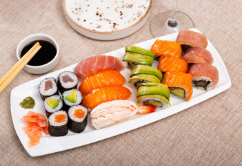 Japanese maki and urumaki roll with salmon and nigiri sushi served with soy sauce