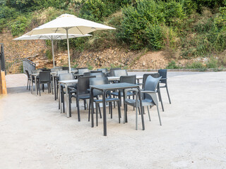 Outdoor cafe tables and chairs with sun umbrella