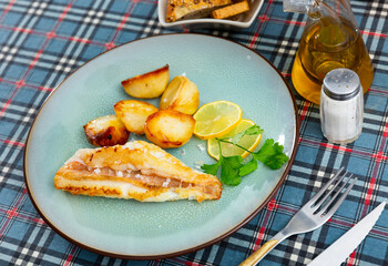 Fried Gallineta fish fillet with potatoes and parsley