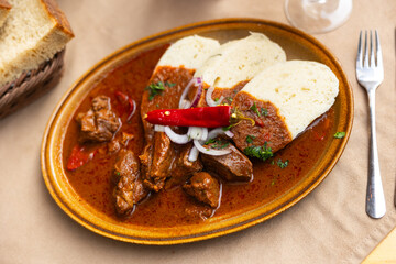 Meat goulash with onions, red hot pepper. Served with bread and gravy. Slovak cuisine